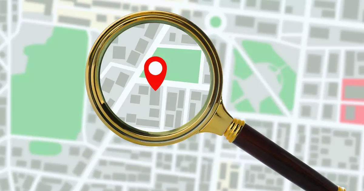 Magnifying glass highlighting a location pin on a city map illustrating local search and Google Maps Service optimization