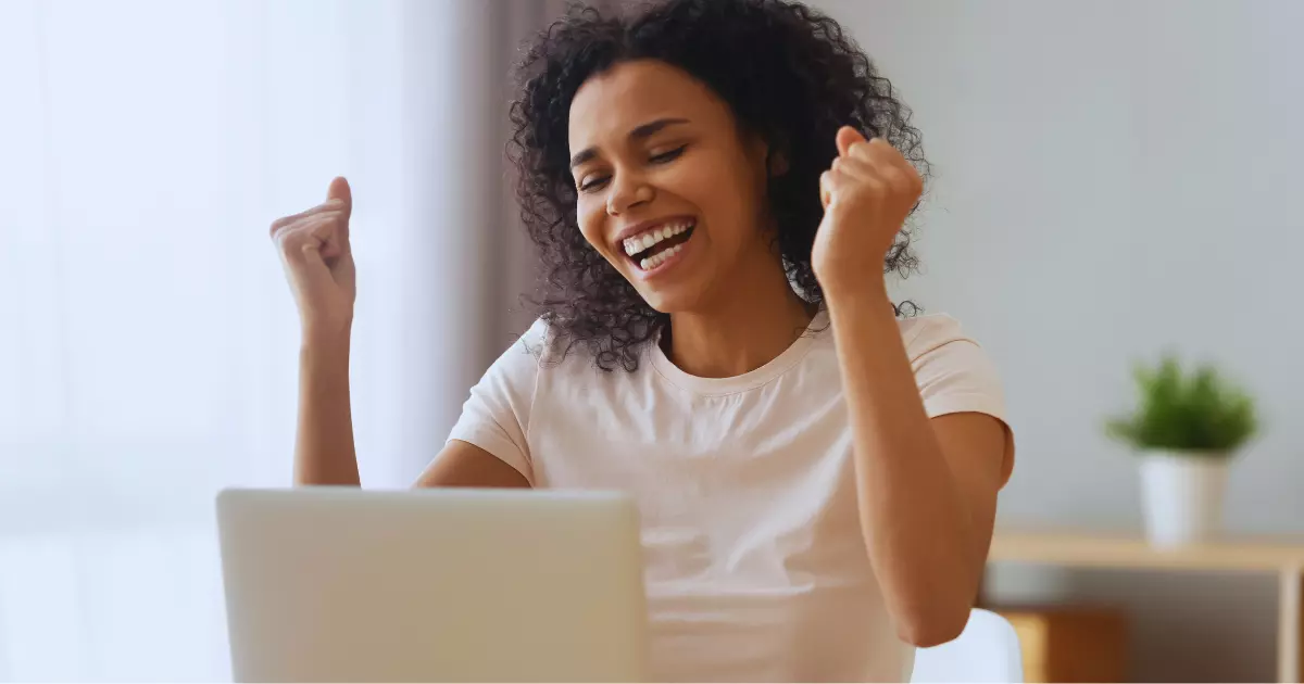 Happy business owner celebrating success after improved online engagement and results from social media service