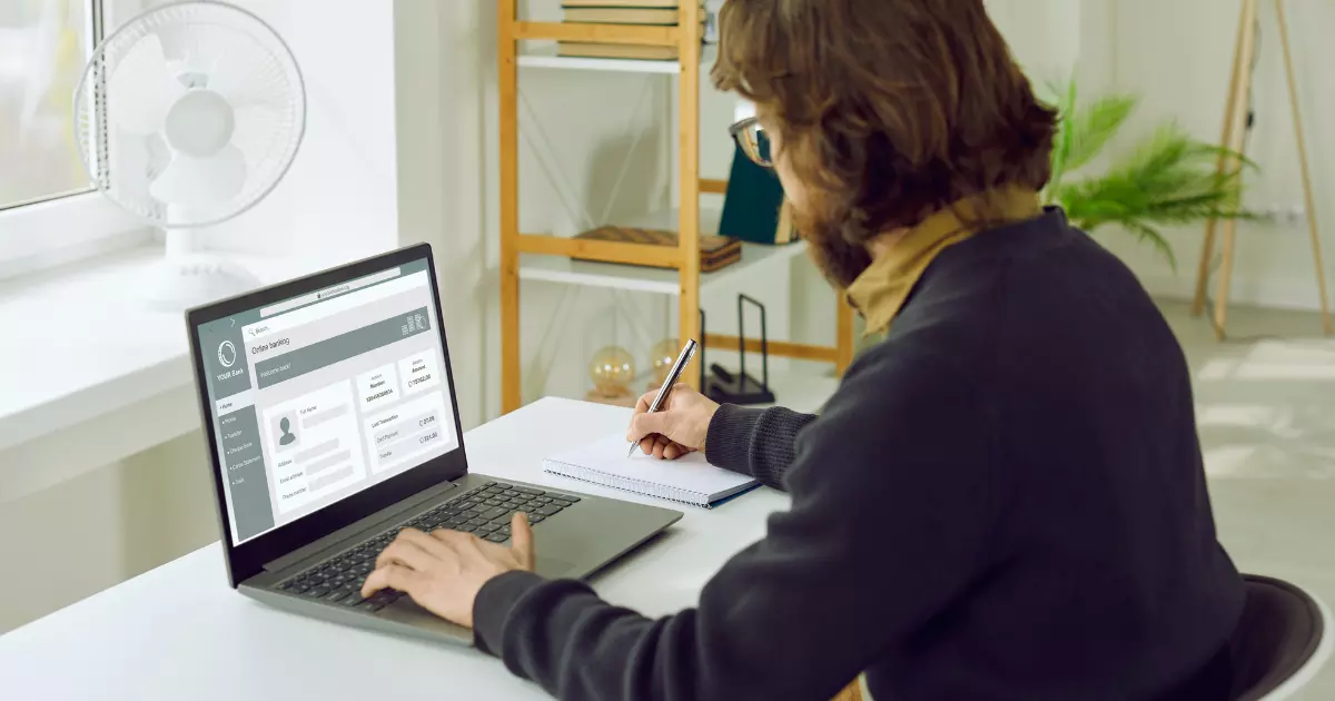 Professional reviewing website dashboard and taking notes illustrating performance tracking through website management service