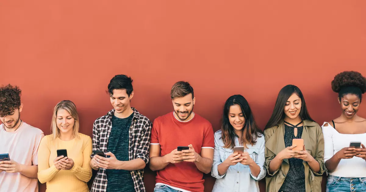 A group of people looking at their phones