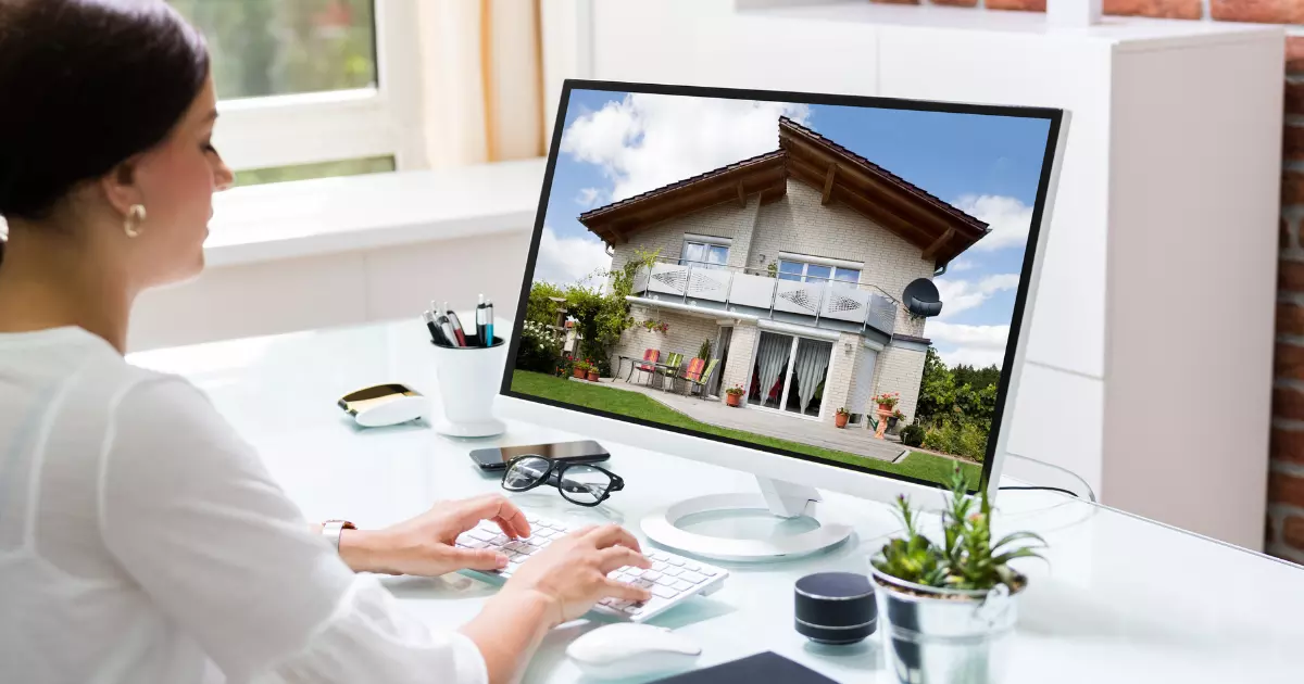 A woman looking a house property on her computer