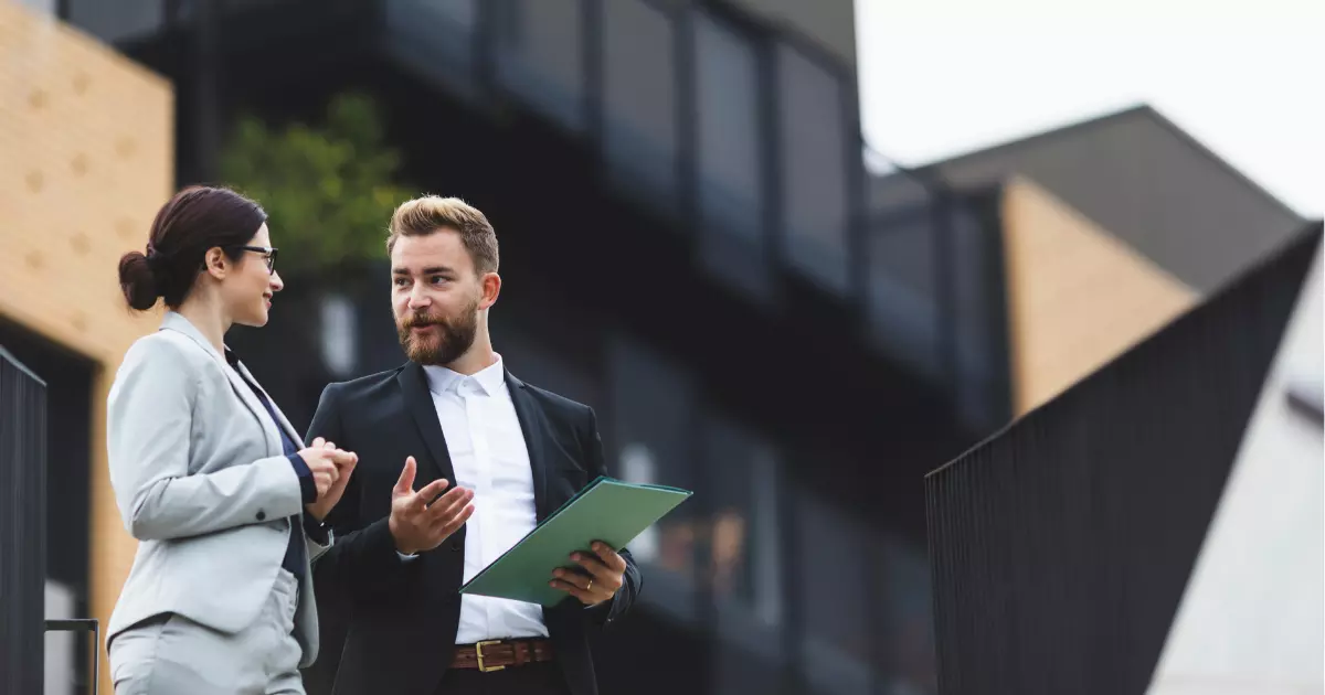 A person in a suit holding a folder 