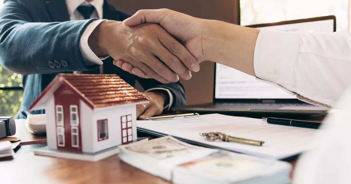 A handshake between a house and a small model house