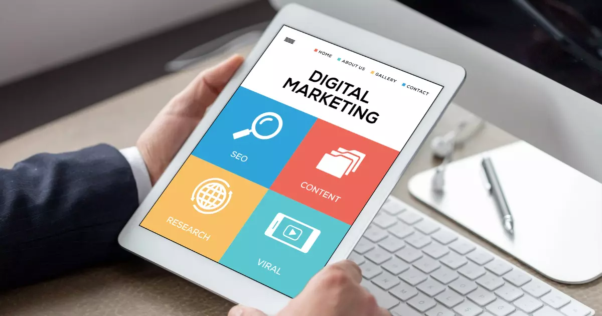 A hand holding a tablet with digital marketing