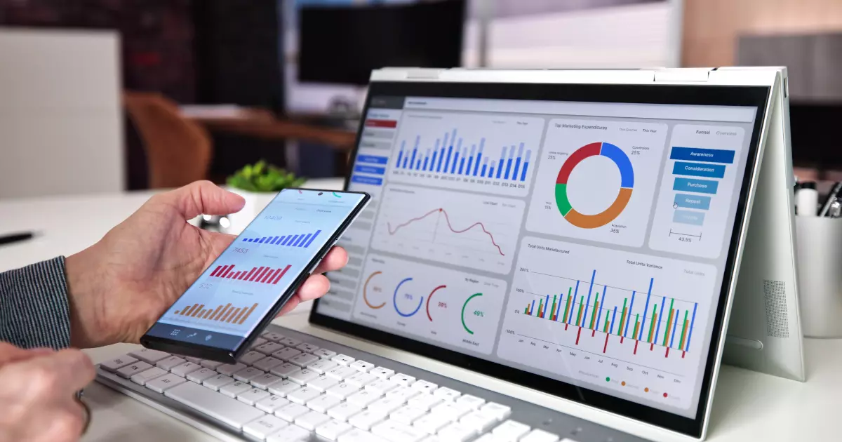 A person analyzing Facebook impressions on both a laptop and smartphone screen showing various colorful charts and graphs